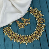 Ornate gold necklace with pearls and gemstones on a blue fabric background