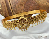 Gold jewelry set on a white fabric with a decorative background