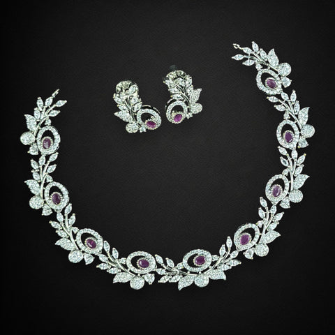 Ornate necklace and earrings set on a black background