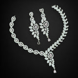 Diamond necklace and earrings set on a black background