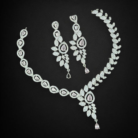 Diamond necklace and earrings set on a black background