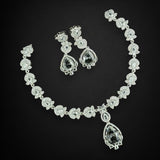 Diamond necklace and earrings set on a black background