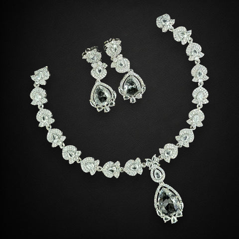 Diamond necklace and earrings set on a black background
