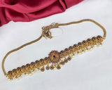 Gold necklace with intricate designs on a white background