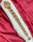 Decorative gold belt with gemstones on a red and white fabric background