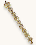 Gold bracelet with gemstones on a white background