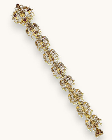Gold bracelet with gemstones on a white background