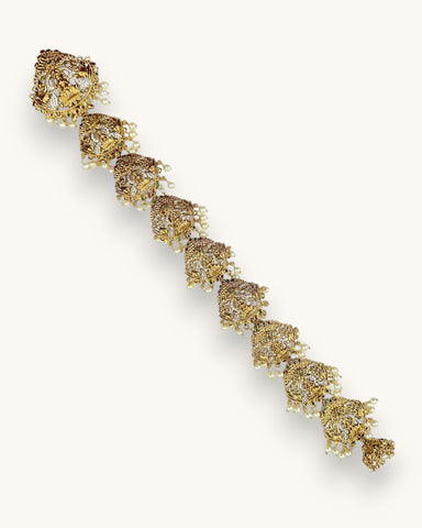 Gold bracelet with floral design on a white background