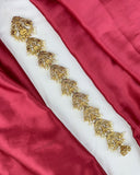 Decorative gold belt on a red fabric background