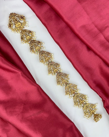 Decorative gold belt on a red fabric background