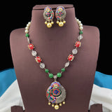 Jewelry set with necklace and earrings on a brown stand