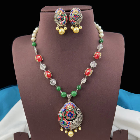 Jewelry set with necklace and earrings on a brown stand