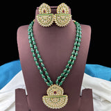 Green beaded necklace with gold pendants and matching earrings on a mannequin.