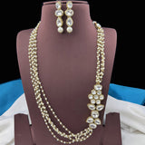 Pearl necklace and earrings on a mannequin bust with a dark background