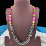 Colorful beaded necklace on a brown mannequin bust with a blurred background