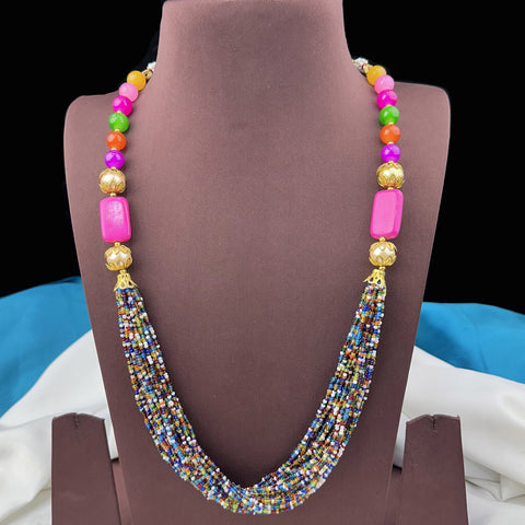 Colorful beaded necklace on a brown mannequin bust with a blurred background