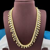 Pearl necklace on a mannequin bust with a dark background