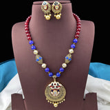 Jewelry set with necklace and earrings on a brown stand