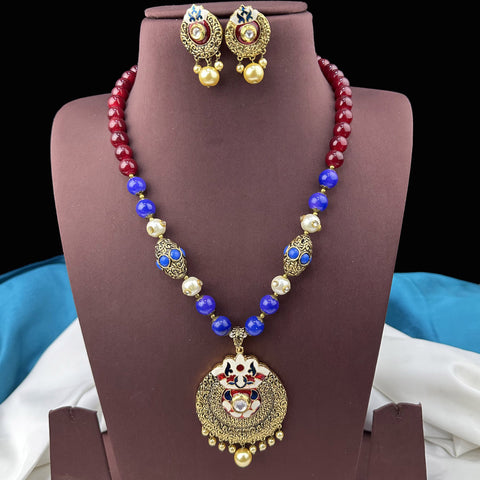 Jewelry set with necklace and earrings on a brown stand