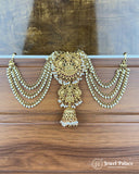 Gold necklace with intricate design on a wooden surface, brand 'Jewel Palace' visible.