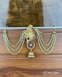 Ornate gold earrings with beads and gemstones on a wooden surface, branded 'Jewel Palace'.