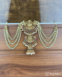 Ornate gold necklace with pearls and gemstones on a wooden surface, brand 'Jewel Palace' visible.