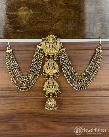 Gold necklace with intricate designs on a wooden surface, featuring the brand 'Jewel Palace'.