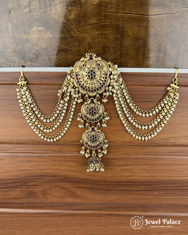 Ornate gold necklace with beads on a wooden surface, brand 'Jewel Palace' visible