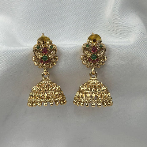 Gold earrings with gemstones on a white background