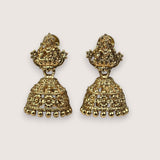 Pair of gold earrings on a light beige background