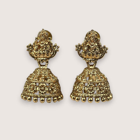 Pair of gold earrings on a light beige background