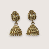 Pair of gold earrings on a light gray background