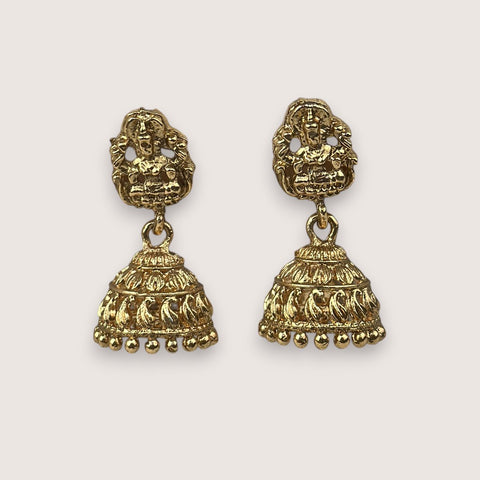 Pair of gold earrings on a light gray background