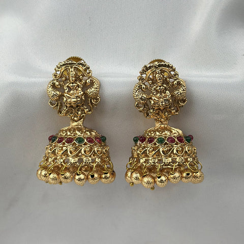 Pair of gold earrings with intricate designs on a white background
