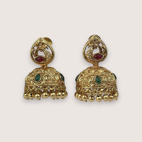 Pair of gold earrings with intricate designs on a light beige background