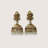 Pair of gold earrings with pearls and gemstones on a white background