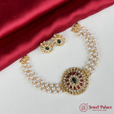 Pearl necklace with gold and gemstone pendants on a red satin background, featuring 'Jewel Palace' branding.