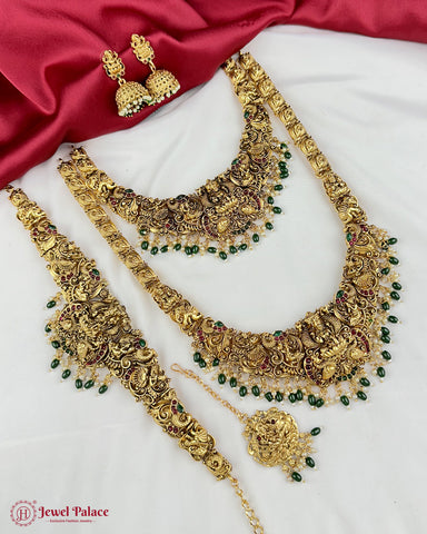 Gold jewelry set with necklaces and earrings on a white background