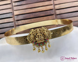 Gold headband with intricate design and decorative elements on a wooden background