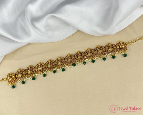 Gold anklet with green beads on a white fabric background, brand 'Jewel Palace' visible.