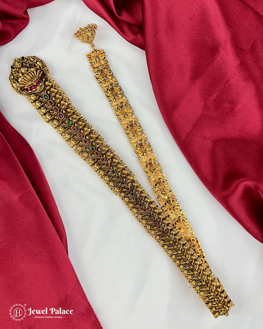 Gold jewelry set with intricate designs on a red and white fabric background, featuring 'Jewel Palace' branding.