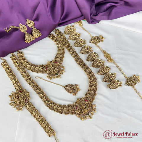 Gold jewelry set including necklace, earrings, and headband on a purple fabric background with 'Jewel Palace' branding.