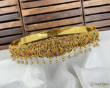 Gold jewelry with gemstones on a white fabric background