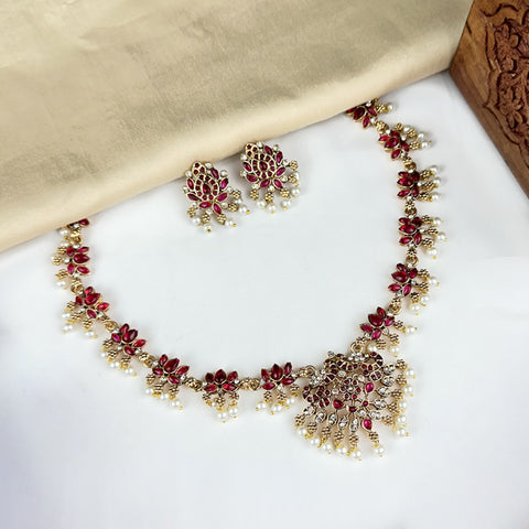 Jewelry set with necklace and earrings on a white surface