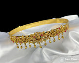 Gold necklace with gemstones on a white satin background, brand 'Jewel Palace' visible