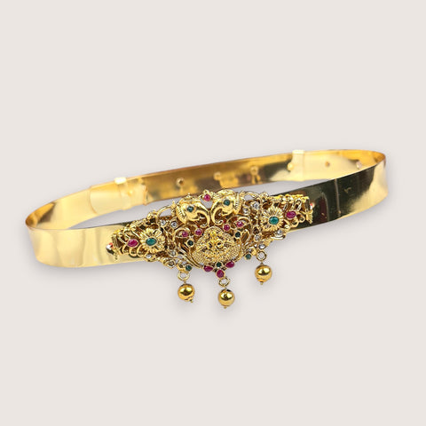 Gold bracelet with intricate designs and gemstones on a light gray background