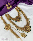 Gold necklace set with green stones on a white and purple fabric background, featuring 'Jewel Palace' branding.
