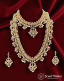 Ornate gold necklace and earrings set on a red satin background with 'Jewel Palace' branding.