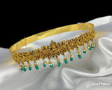 Gold bracelet with green and red stones on a white satin background, branded 'Jewel Palace'.