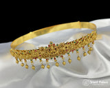 Gold headband with gemstones on a white satin background, branded 'Jewel Palace'.